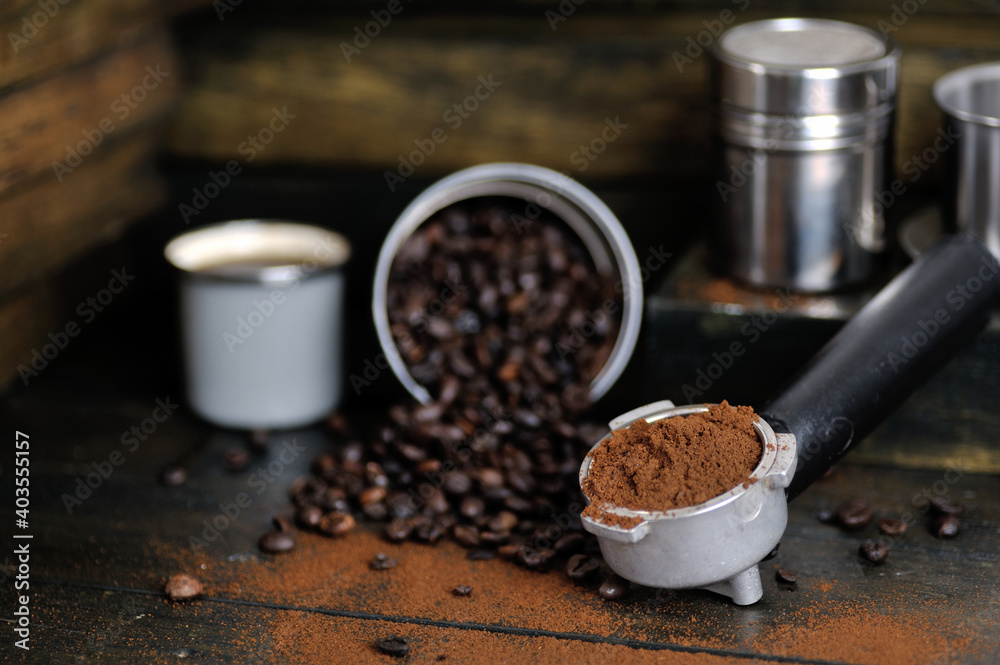 Fototapeta premium coffee bean cup and porta filter with coffee powder inside and Vietnam Drip Coffee on wooden table