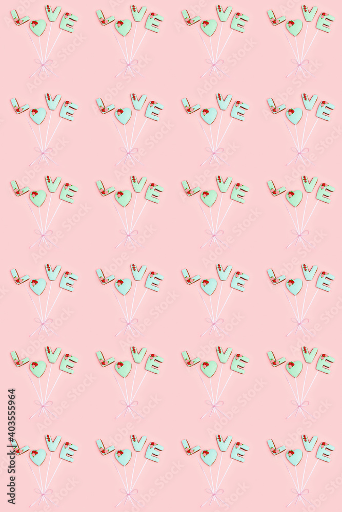 Regular pattern from homemade gingerbreads with letters love as balloons connected by ribbon. Saint Valentine day texture. Holiday food concept. Regular pattern from homemade gingerbreads with letters love as balloons connected by ribbon. Saint Valentine day texture. Holiday food concept.