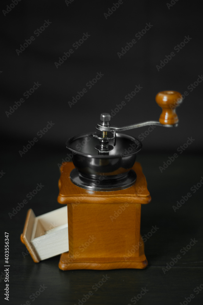 Antique coffee grinder isolated on a black background Antique coffee grinder isolated on a black background