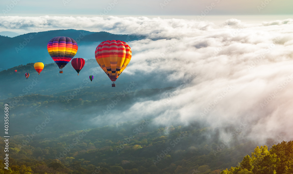 Colorful hot-air balloons flying over the mountain and sea of mist, Doi Inthanon Natural Park Chiang Mai, Thailand