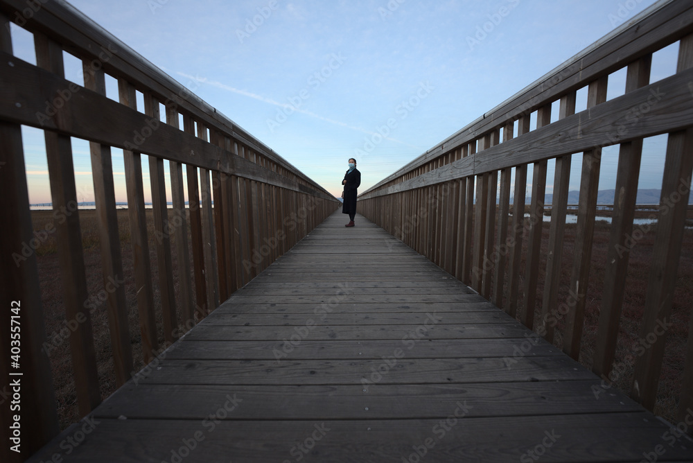 Fototapeta premium walking on wooden bridge with mask