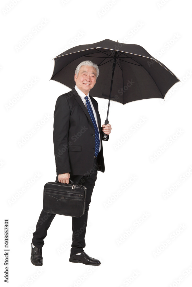 An old senior businessman with briefcase and umbrella An old senior businessman with briefcase and umbrella