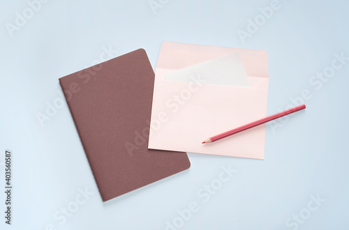 flat lay pink letter and pencil stationery