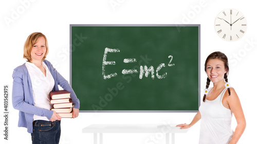 Young teacher and schoolgirl in front of a chalkboard, relativity equation, e equals mc squared, is written on the board, isolated on white background