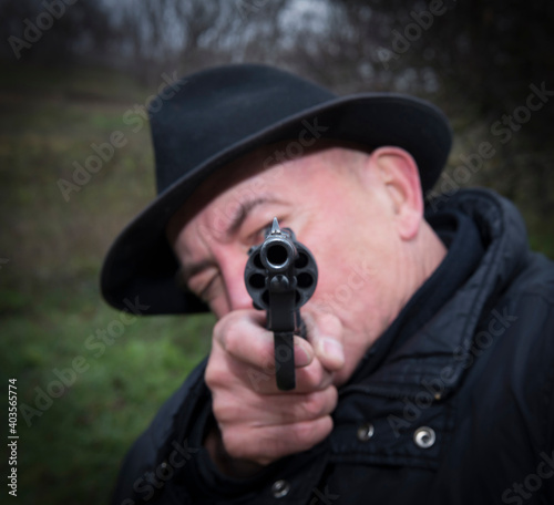 Man aiming a gun Nagan © Aleksandr
