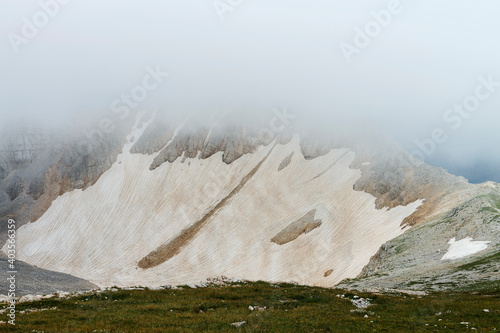 Clouded mountain glacier on the way to peak of mount Oshten in the western Caucasus, in the Republic of Adygea, southwestern Russia 
