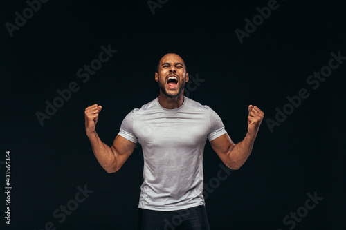 Muscular athlete shouting in joy photo