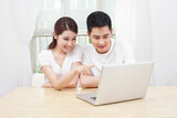 A young Couple Using Laptop at Home