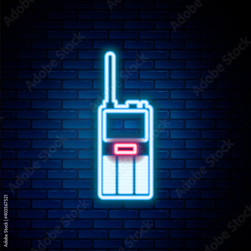 Glowing neon line Walkie talkie icon isolated on brick wall background. Portable radio transmitter icon. Radio transceiver sign. Colorful outline concept. Vector.