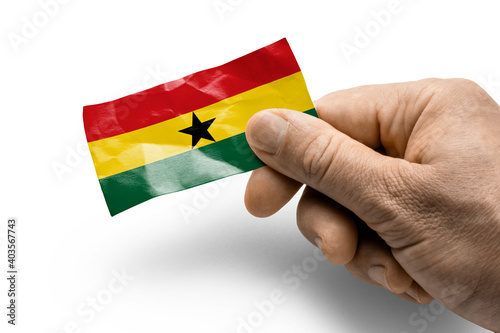Hand holding a card with a national flag the Ghana