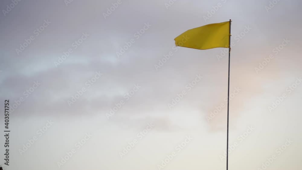 Yellow Flag In Wind At Sunrise Yellow Flag In Wind At Sunrise