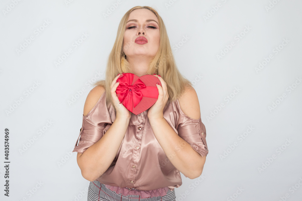 dreaming woman in pink blouse holding red gift box heart dreaming woman in pink blouse holding red gift box heart