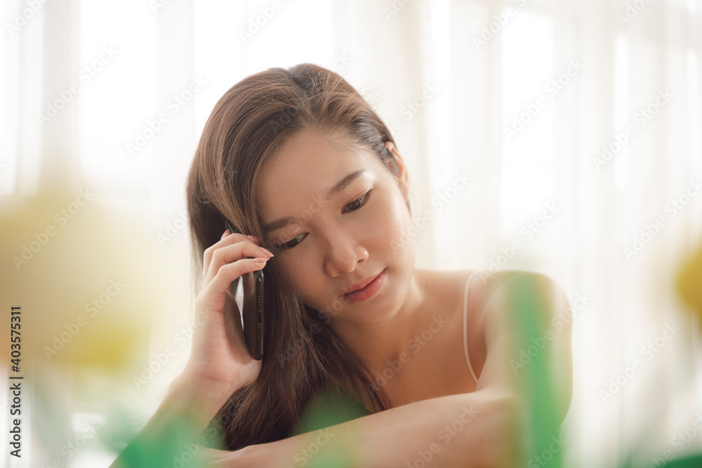 Portrait of young asian beauty woman using smartphone in soft light room. Portrait of young asian beauty woman using smartphone in soft light room.