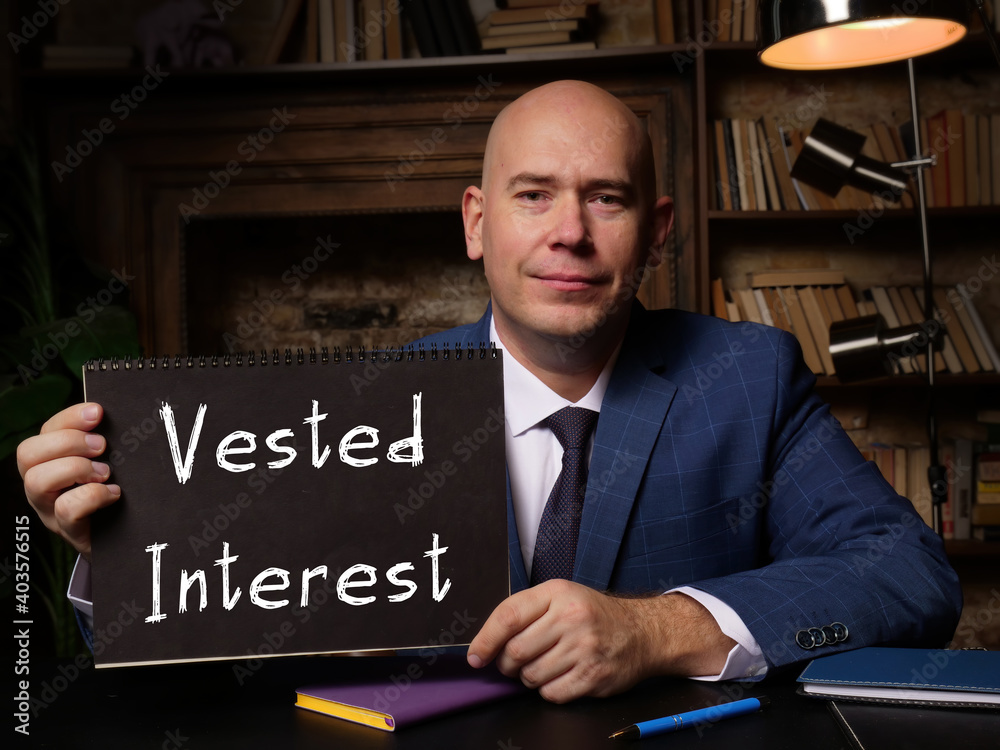 custom made wallpaper toronto digitalMan wearing blue business suit and showing blank black notepad with written text Vested Interest .