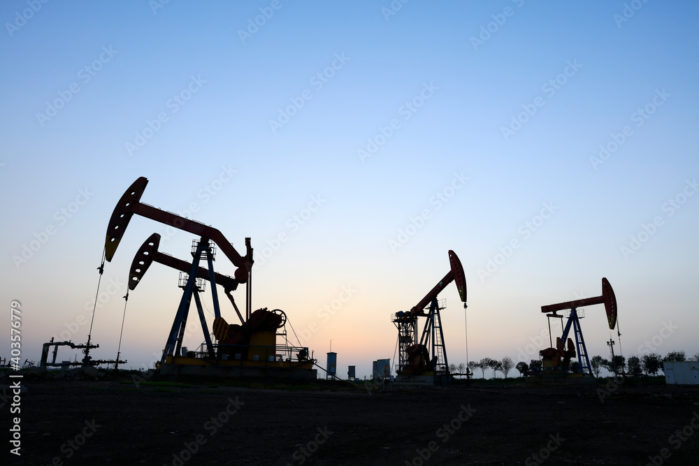 the oil pump in the evening, the evening silhouette of the pumping unit, the silhouette of the oil pump the oil pump in the evening, the evening silhouette of the pumping unit, the silhouette of the oil pump