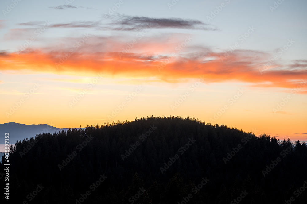 autumn sunset over a forested hill in Emmental