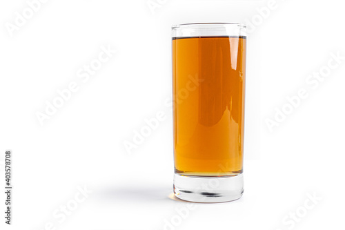 Apple juice in glass on a white background.