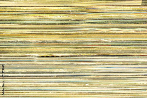 A stack of old magazines with shabby pages background.