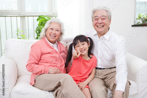 Happy grandparents and grandchildren are playing in the living room 