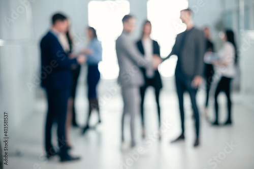 background image of a group of corporate employees in the office lobby
