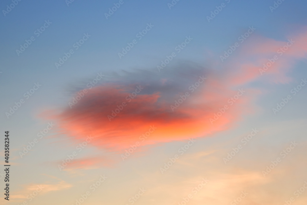 The sky at sunset. A bright red cloud in the evening sky.