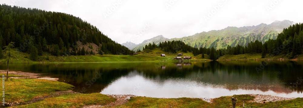 houses on the shore from a mountain lake panorama