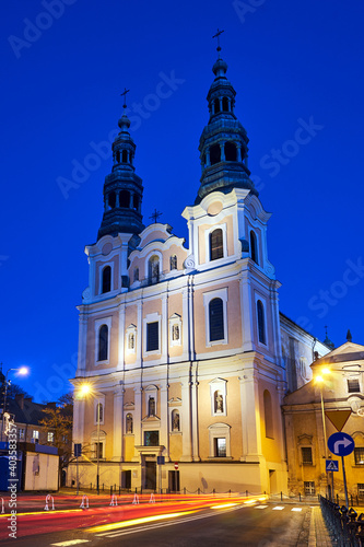 facade and bell towers of a baroque church during the night