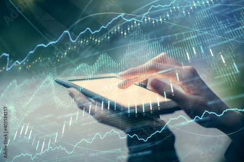 Double exposure of forex chart sketch hologram and woman holding and using a mobile device. Financial market concept.