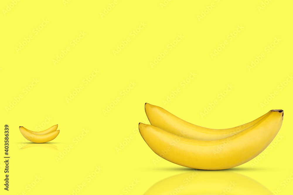 Fresh and sweet bananas on yellow background.