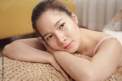 Young asian beauty woman laying on her hands on the floor.