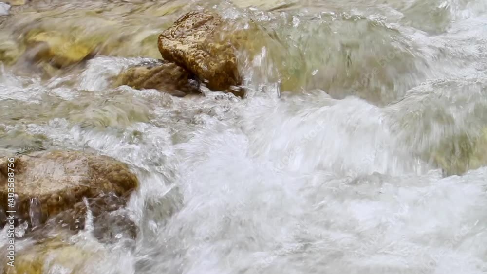 A torrential stream in a rocky riverbed in Alps, Italy A torrential stream in a rocky riverbed in Alps, Italy