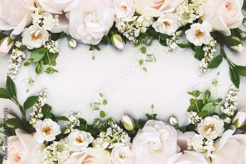 Delicate blossoming light white rose frame, blooming flowers pastel festive background, soft bouquet floral card, toned 