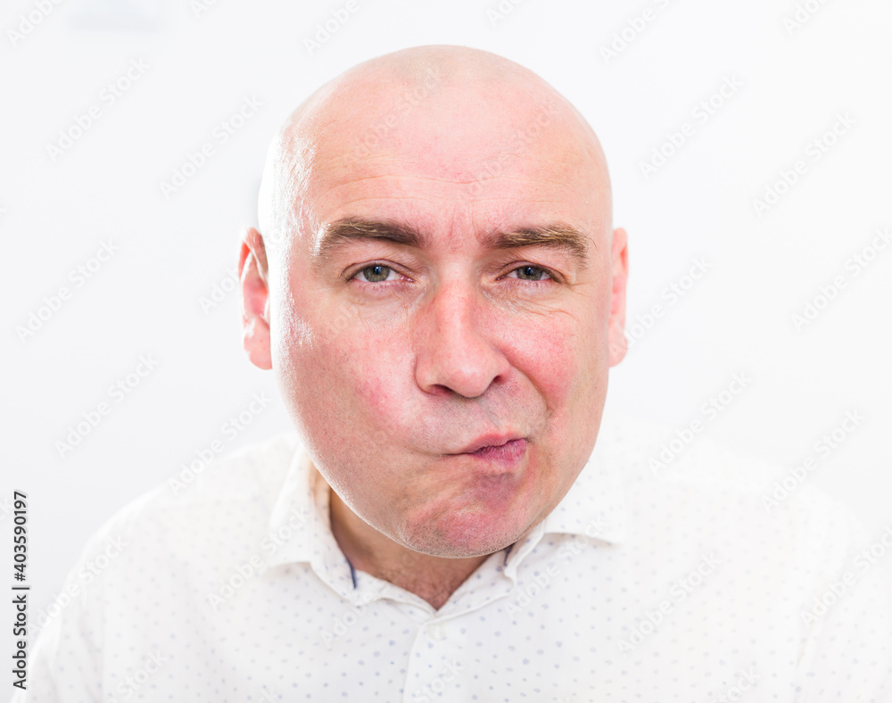 portrait of bald adult mature man with emotions on white background portrait of bald adult mature man with emotions on white background