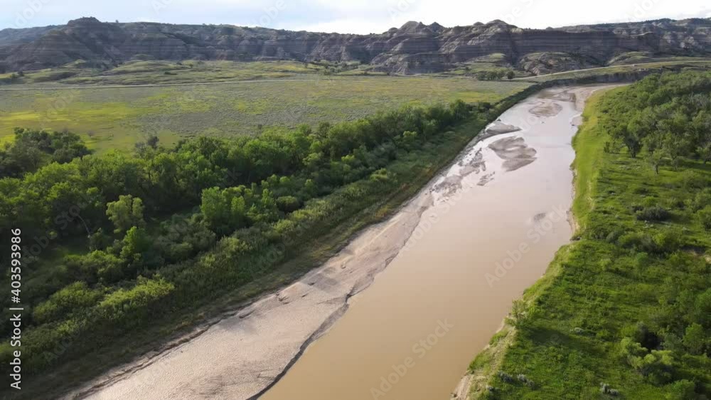 Flying over Little Missouri River at an angle just outside of Theodore Roosevelt National Park in North Dakota on a summer day Flying over Little Missouri River at an angle just outside of Theodore Roosevelt National Park in North Dakota on a summer day