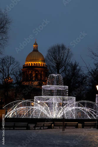 christmas new year street decoration fountain of lights in the night in Saint Petersburg, Russia with Staint Isaac's cathedral on the background