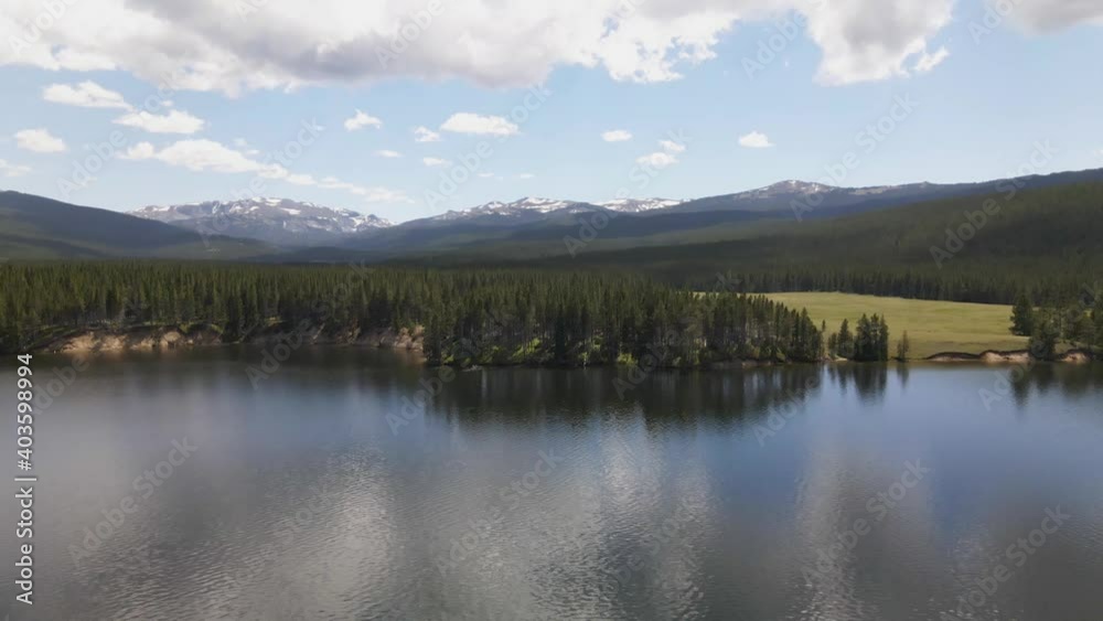 Aerial view of the shore of Park Reservoir with Clouds Peak Wilderness in the background in Bighorn National Forest in Wyoming on a summer day Aerial view of the shore of Park Reservoir with Clouds Peak Wilderness in the background in Bighorn National Forest in Wyoming on a summer day