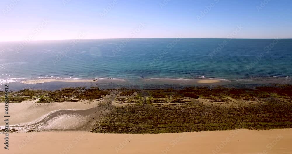 Aerial fly from a sandy beach over the intertidal beach to the ocean waves, Gulf of California, Mexico. Aerial fly from a sandy beach over the intertidal beach to the ocean waves, Gulf of California, Mexico.