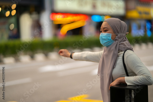 Young teenager waiting vehicle at stop station.