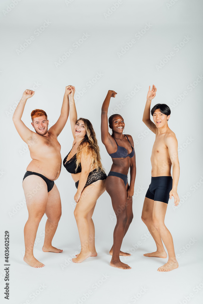 Fotografia do Stock: Group of young people wearing underwear, arms raised