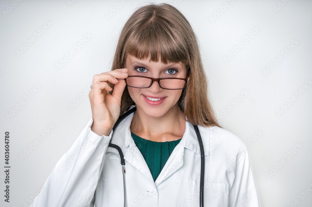 Portrait of successful doctor with stethoscope on white