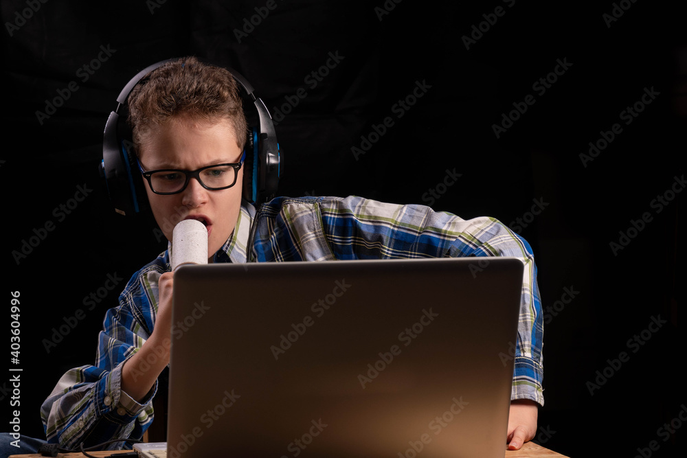 Boy with lint roller learning in front of laptop Boy with lint roller learning in front of laptop