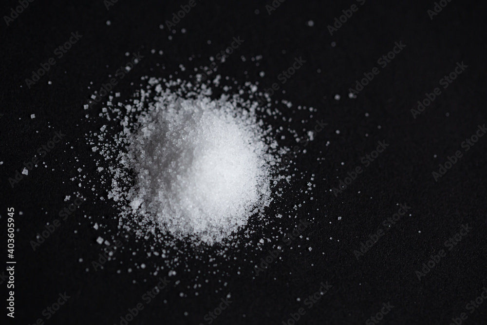 pile of sea salt on black background. selective focus pile of sea salt on black background. selective focus
