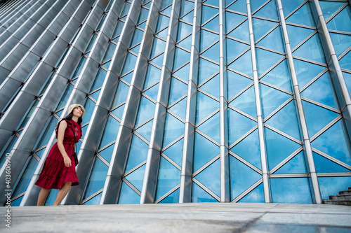 Asian woman in red dress at modern building, female girl with urban city lifestyle © chokniti