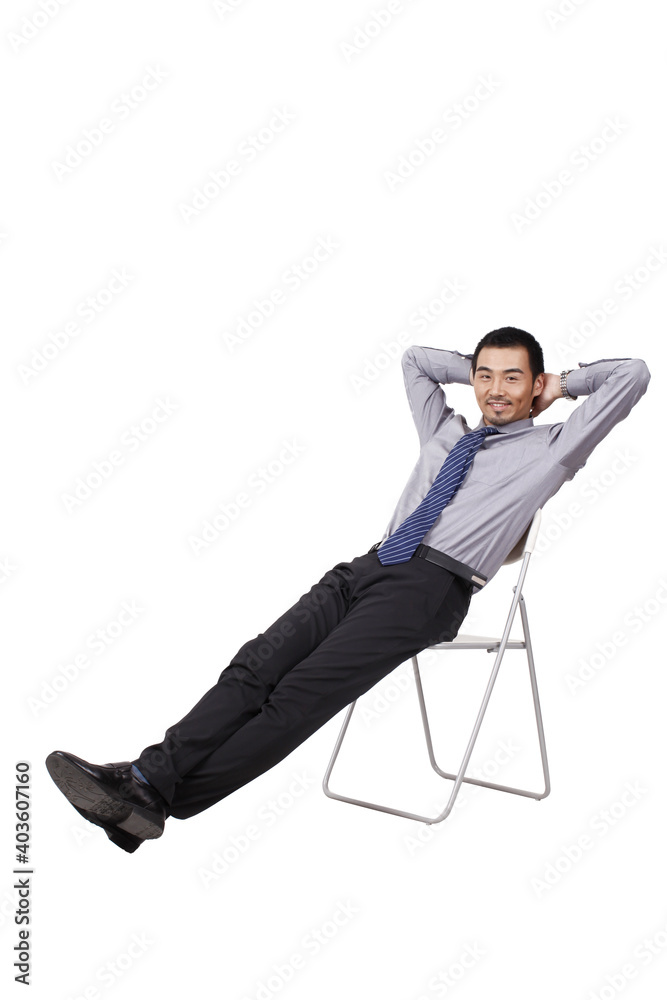 A cheerful young business man sitting posture A cheerful young business man sitting posture