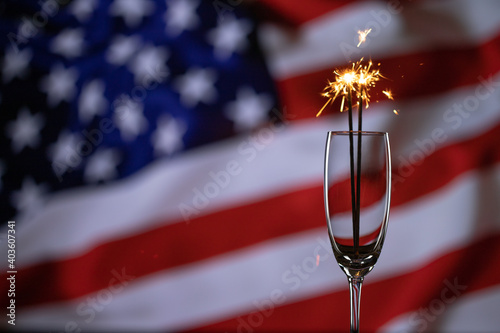Happy 4th of July, independence day USA. Sparkler on american flag background