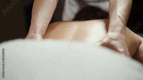 Relaxing massage, lymphatic drainage of the female body in the spa salon.