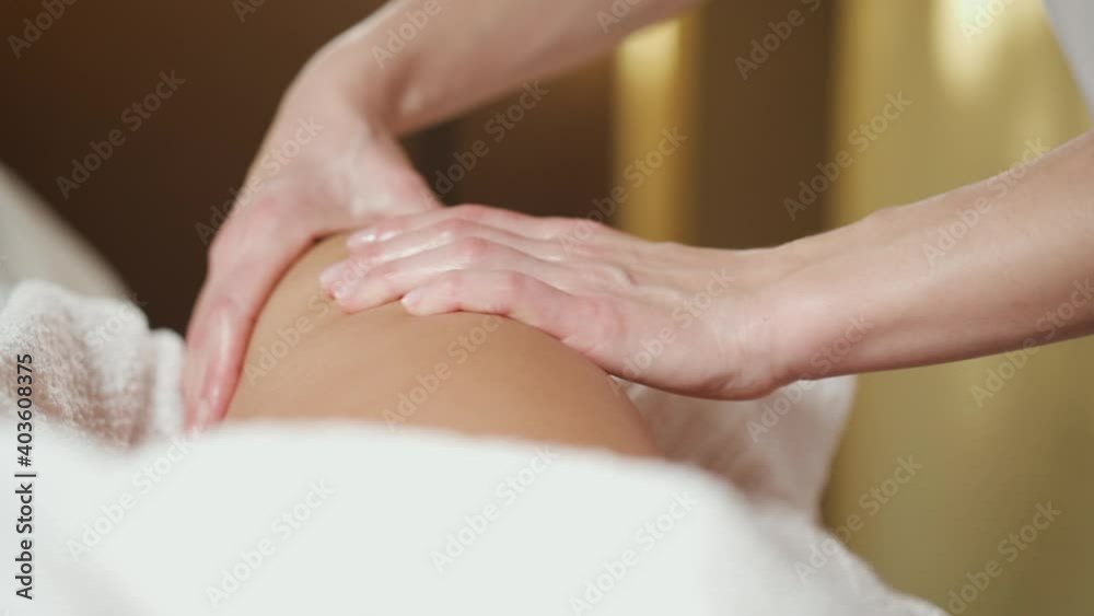 A woman massage specialist conducts a procedure in a spa salon. A woman massage specialist conducts a procedure in a spa salon.