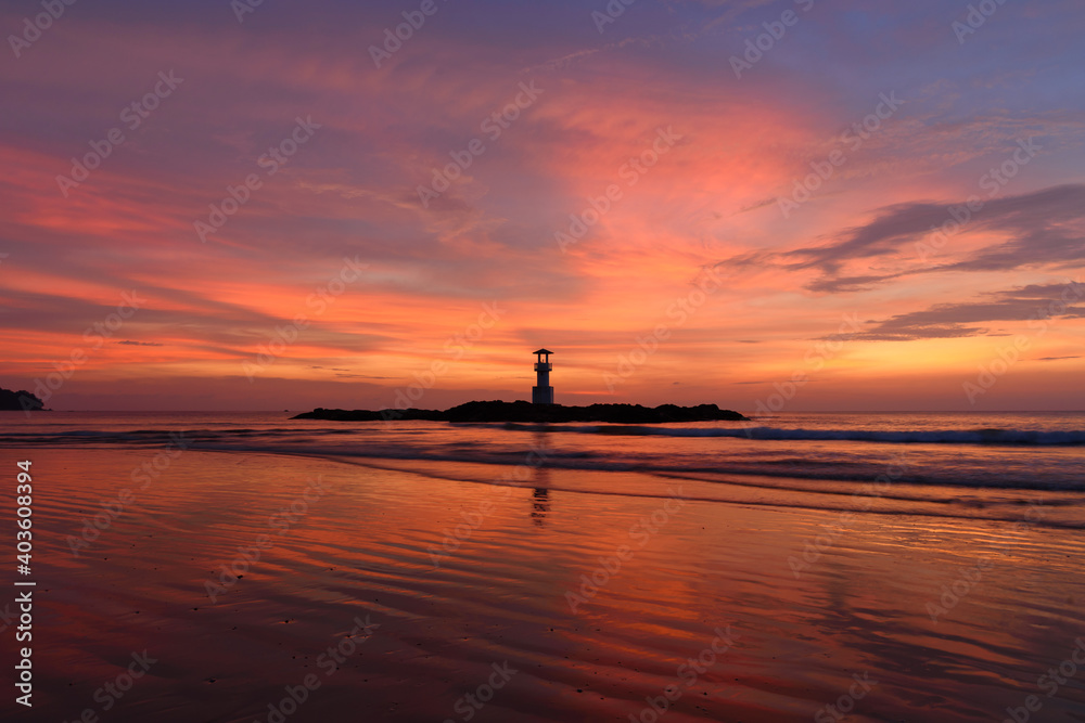 The scenery of the silhouette Khao Lak lighthouse in sunset time with the dramatic twilight sky at Phang-Nga, Thailand.