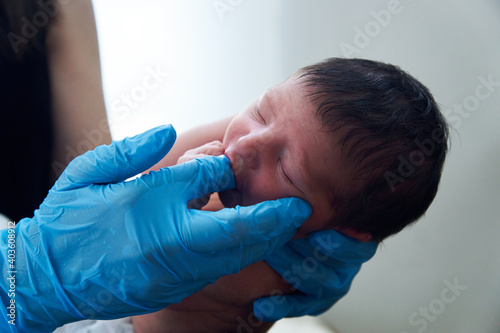 Young female doctor with newborn baby