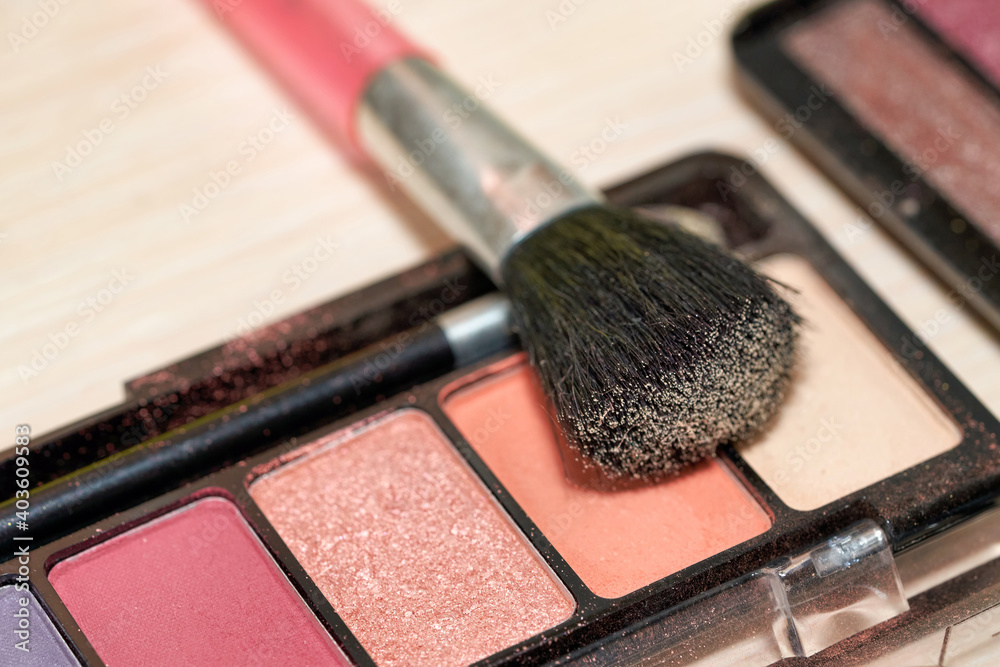 Set of multi colored eyeshadows with makeup brush Set of multi colored eyeshadows with makeup brush